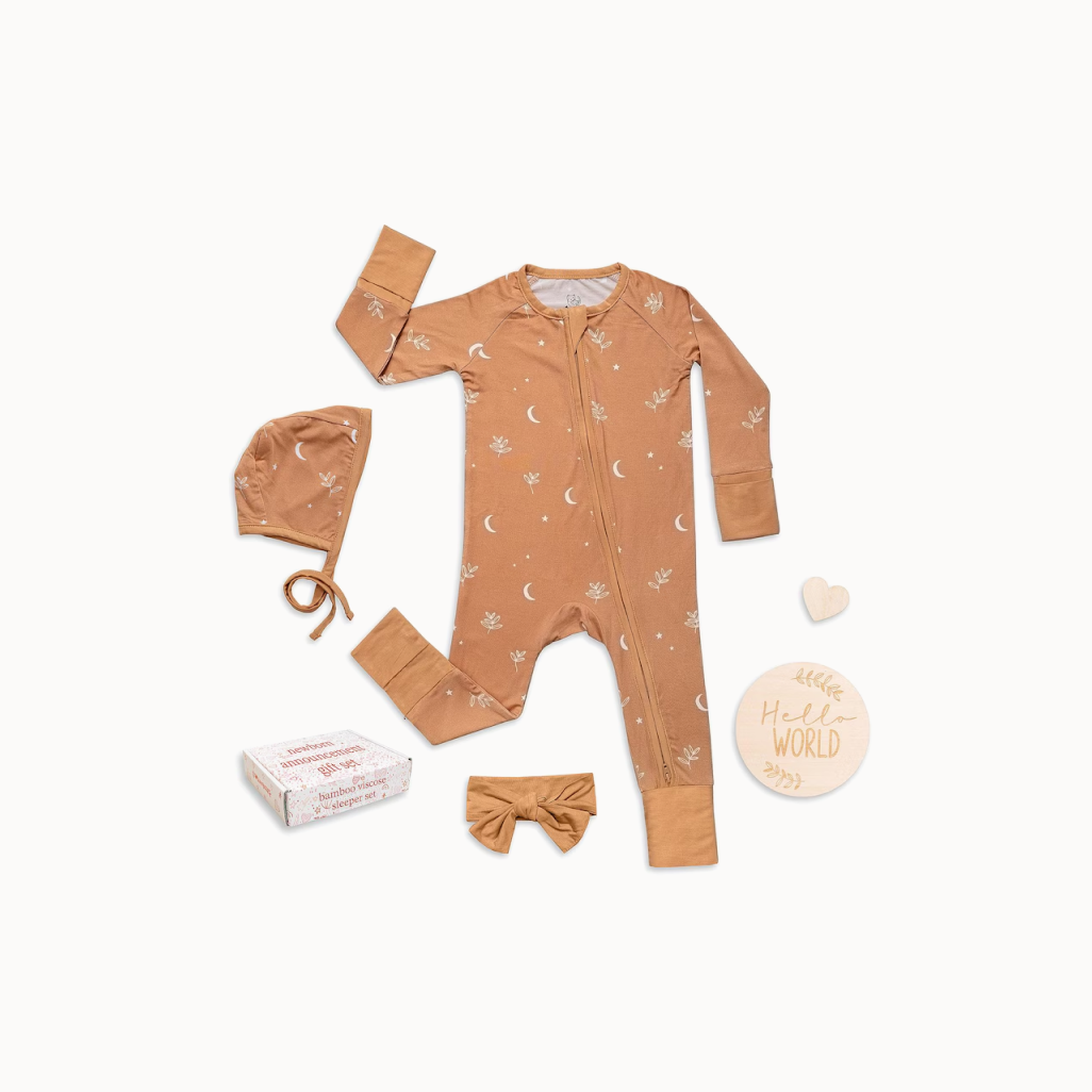 Baby outfit set with onesie, hat, and headband on a white background