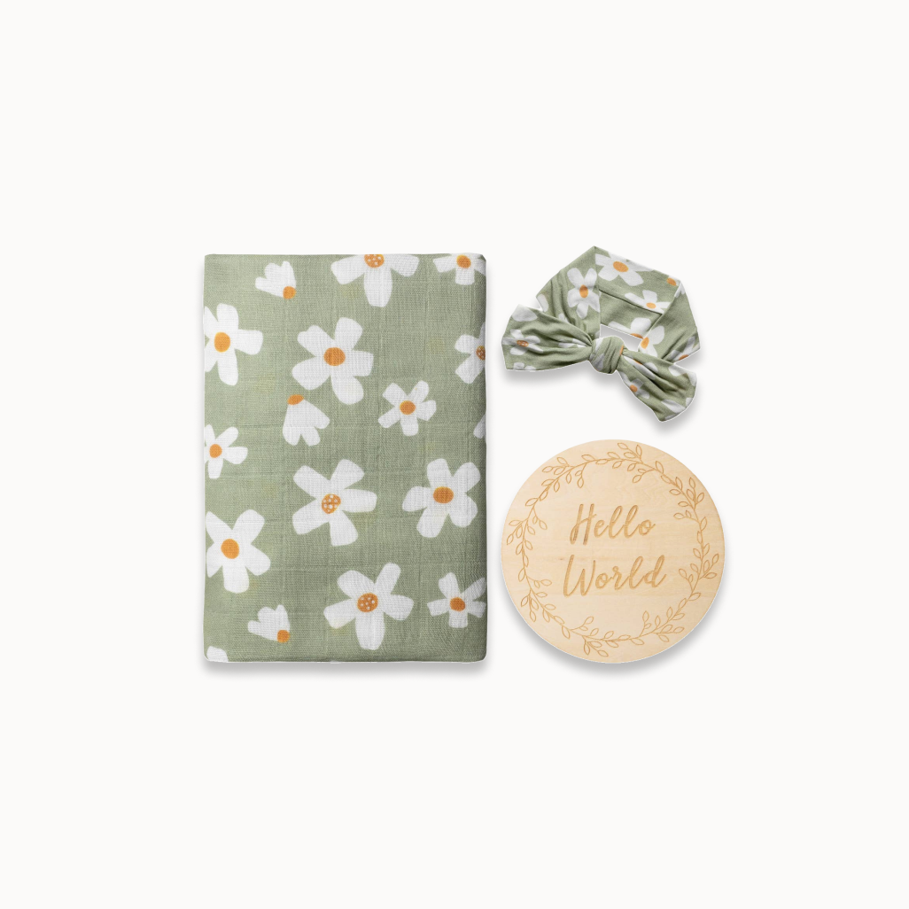 Baby items set with floral patterned blanket, headband, and 'Hello World' plaque on a white background