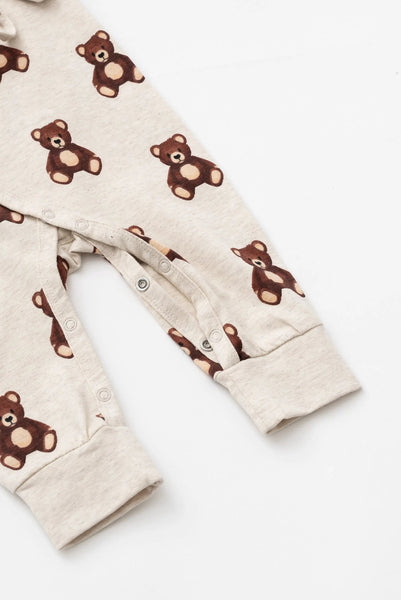 Baby onesie with teddy bear pattern on a white background