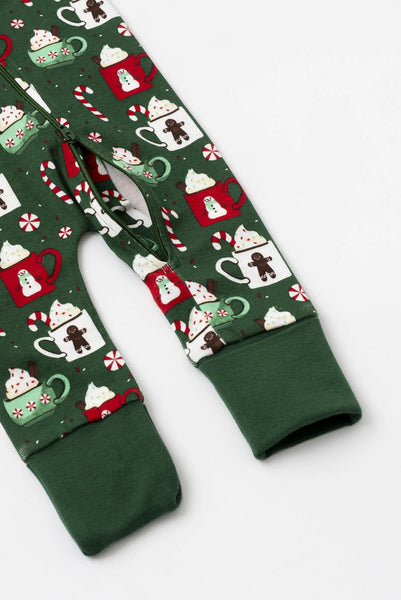 Green baby leggings with Christmas-themed pattern on a white background