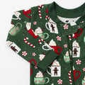Green children's onesie with festive pattern on a white background