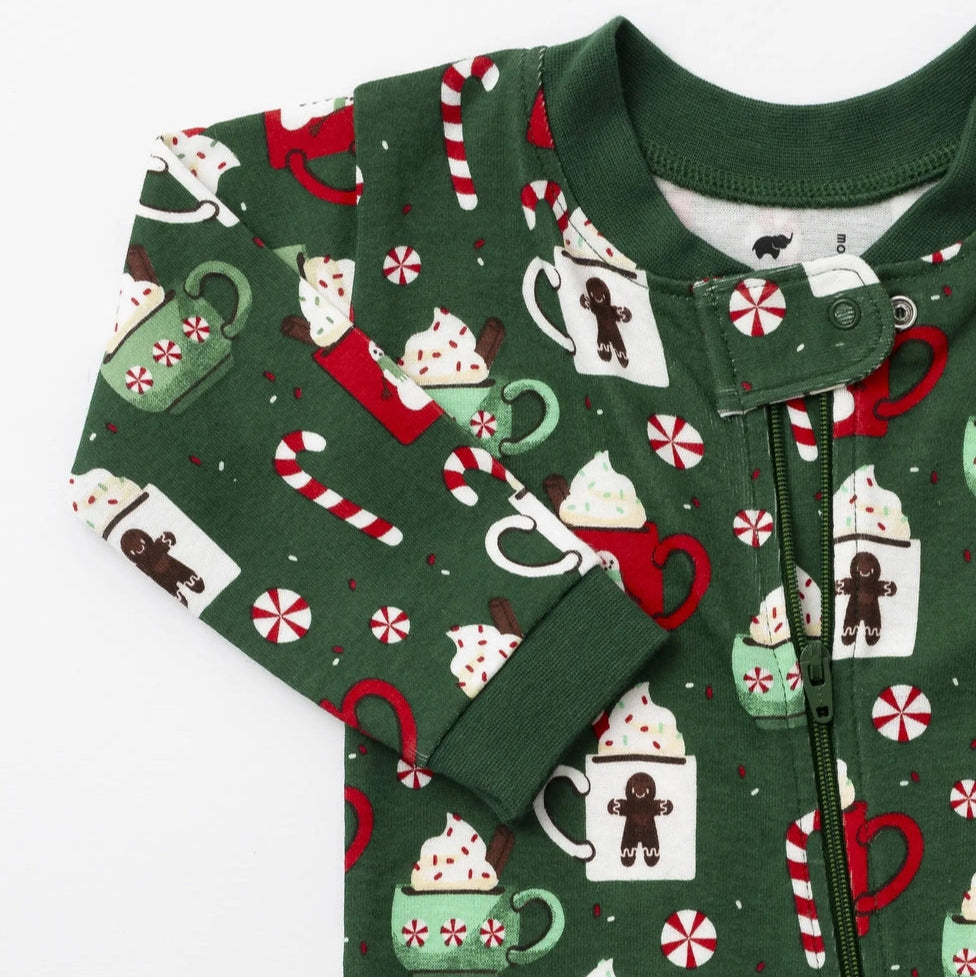 Green children's onesie with festive pattern on a white background