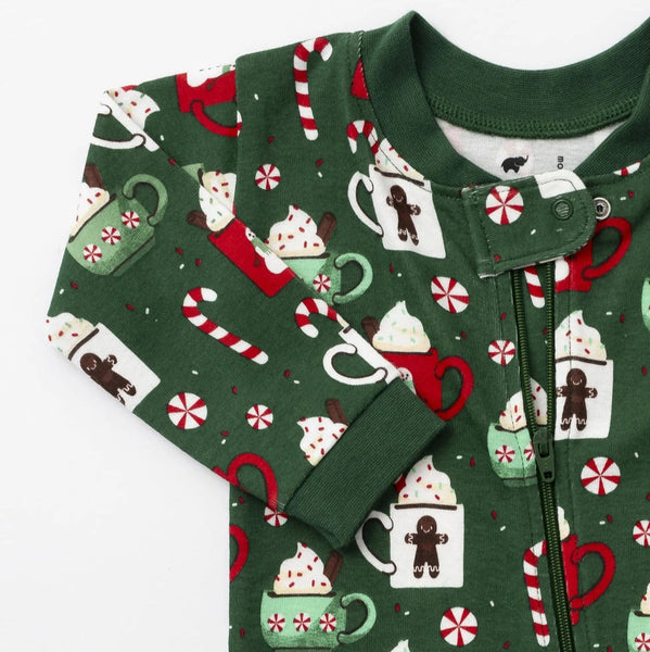 Green children's onesie with festive pattern on a white background