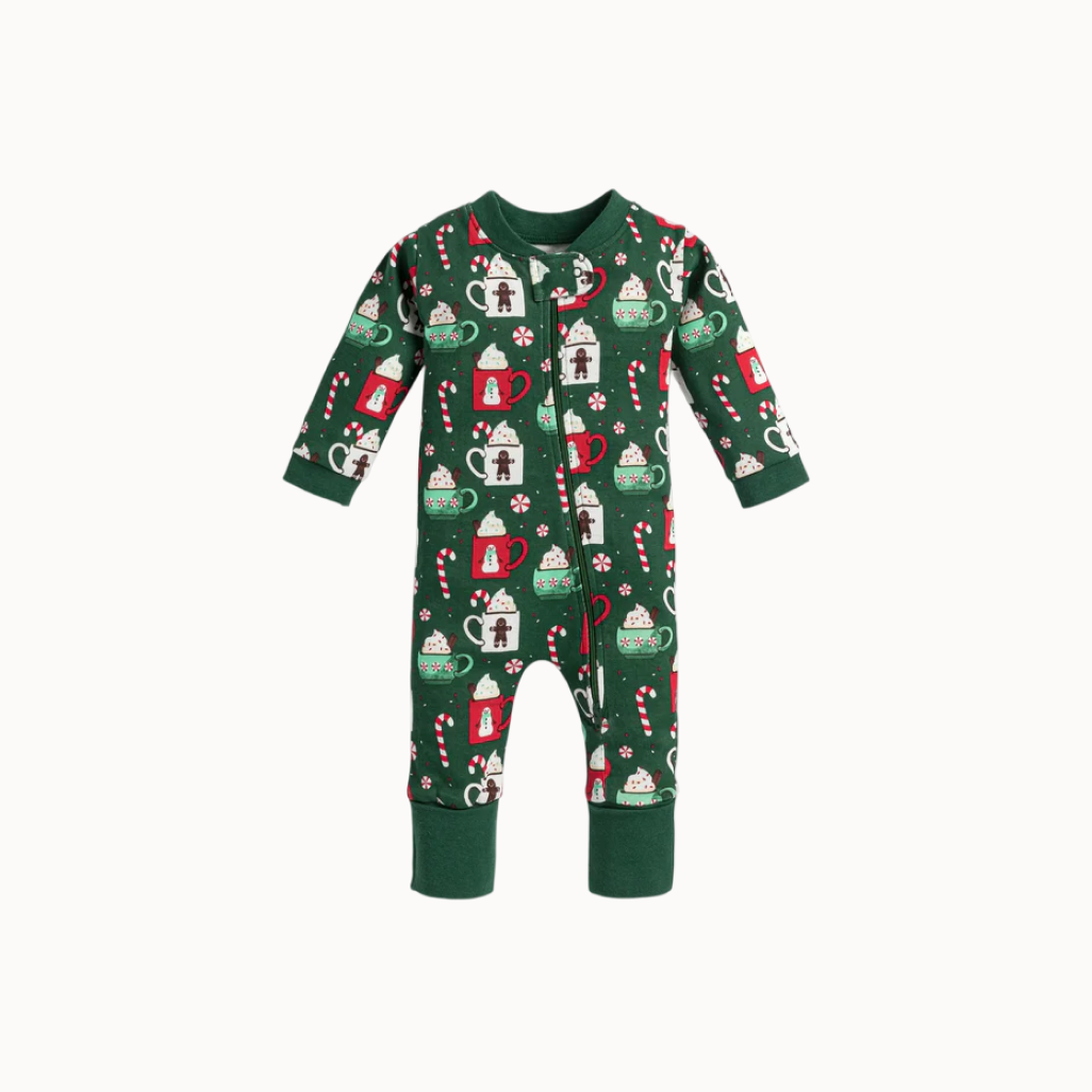 Green baby onesie with festive pattern on a white background