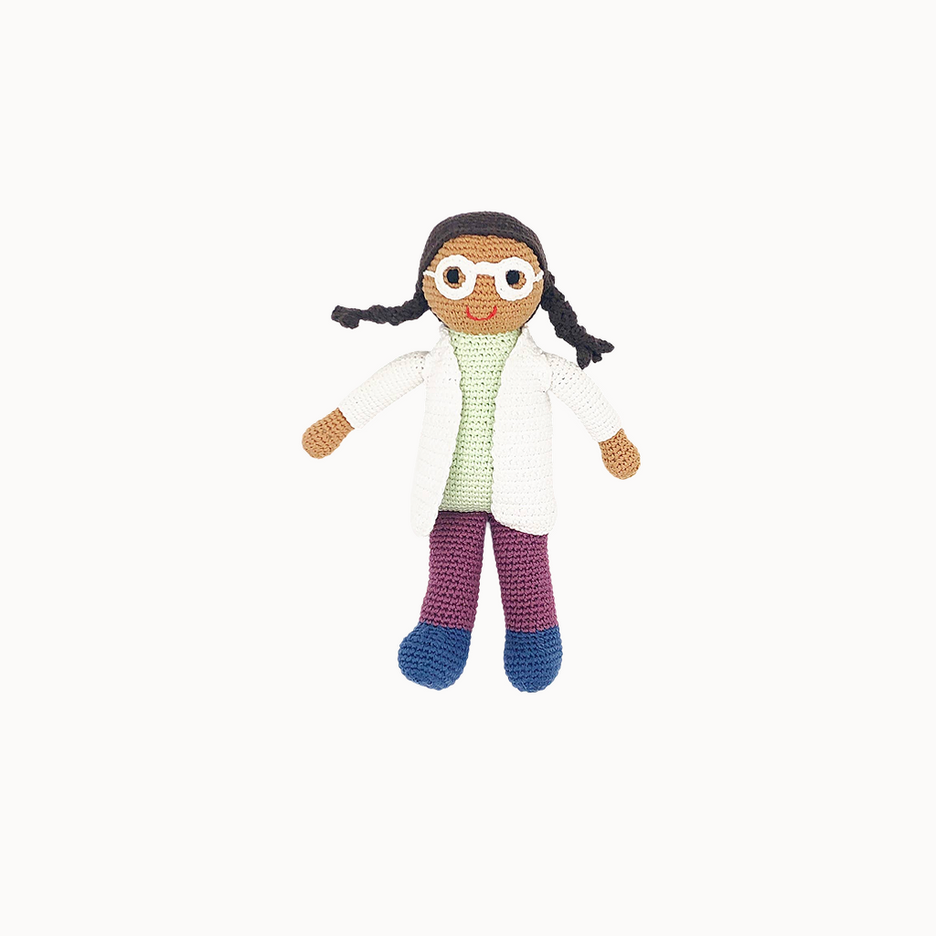 Crocheted doll with a white lab coat, green shirt, purple pants, and blue shoes on a white background