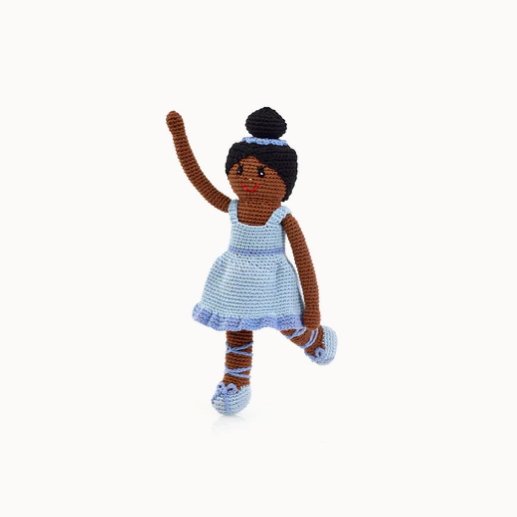 Crocheted doll with brown hair and a blue dress on a white background