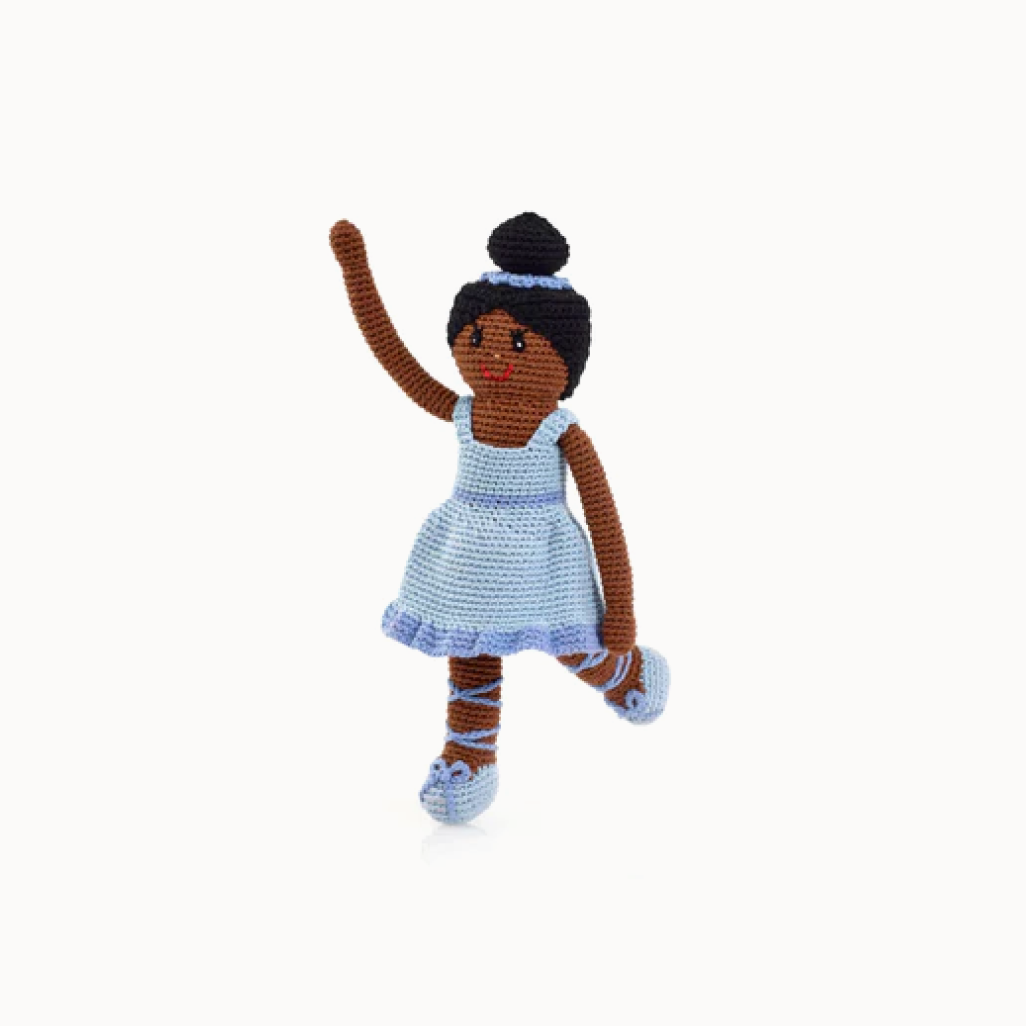 Crocheted doll with brown hair and a blue dress on a white background