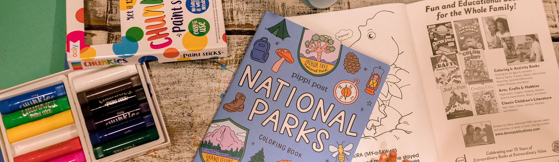 Top view of fun coloring books and paint sticks.
