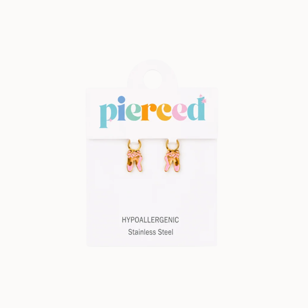 A pair of gold hoop earrings with pink and gold bunny charms, displayed on a white card labeled 'pierced' with text reading 'Hypoallergenic Stainless Steel'.