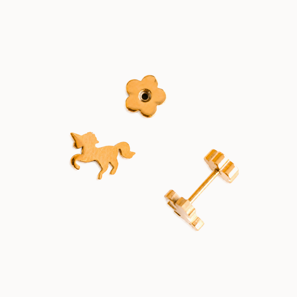 Gold unicorn-shaped earrings on a white background