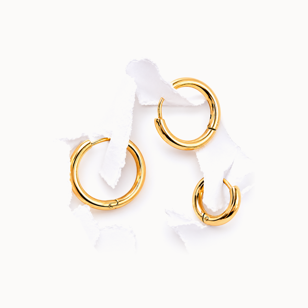 Gold hoop earrings on a white background
