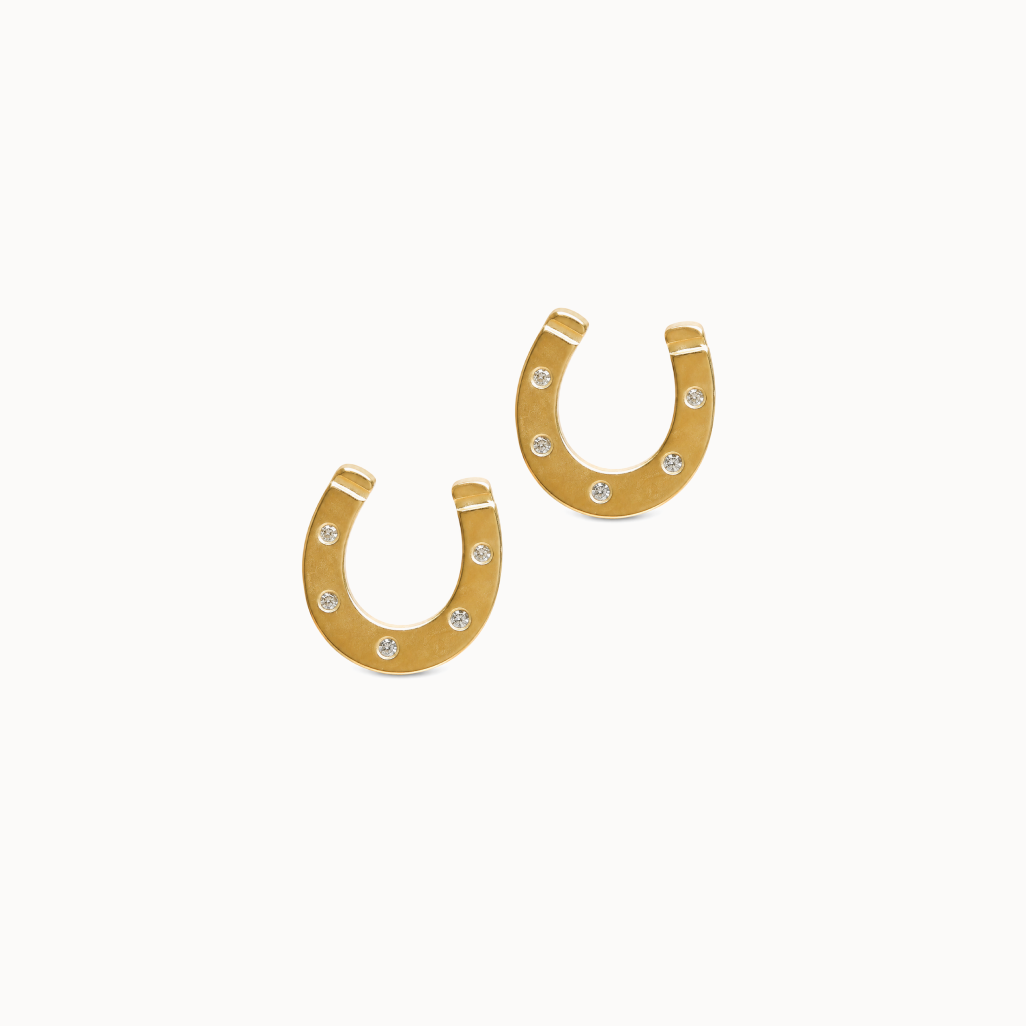 Gold horseshoe-shaped earrings on a white background