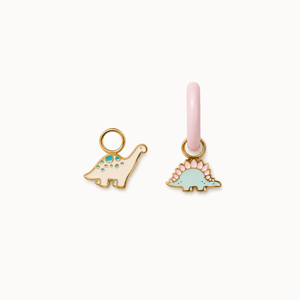 Two dinosaur-shaped charms on a white background