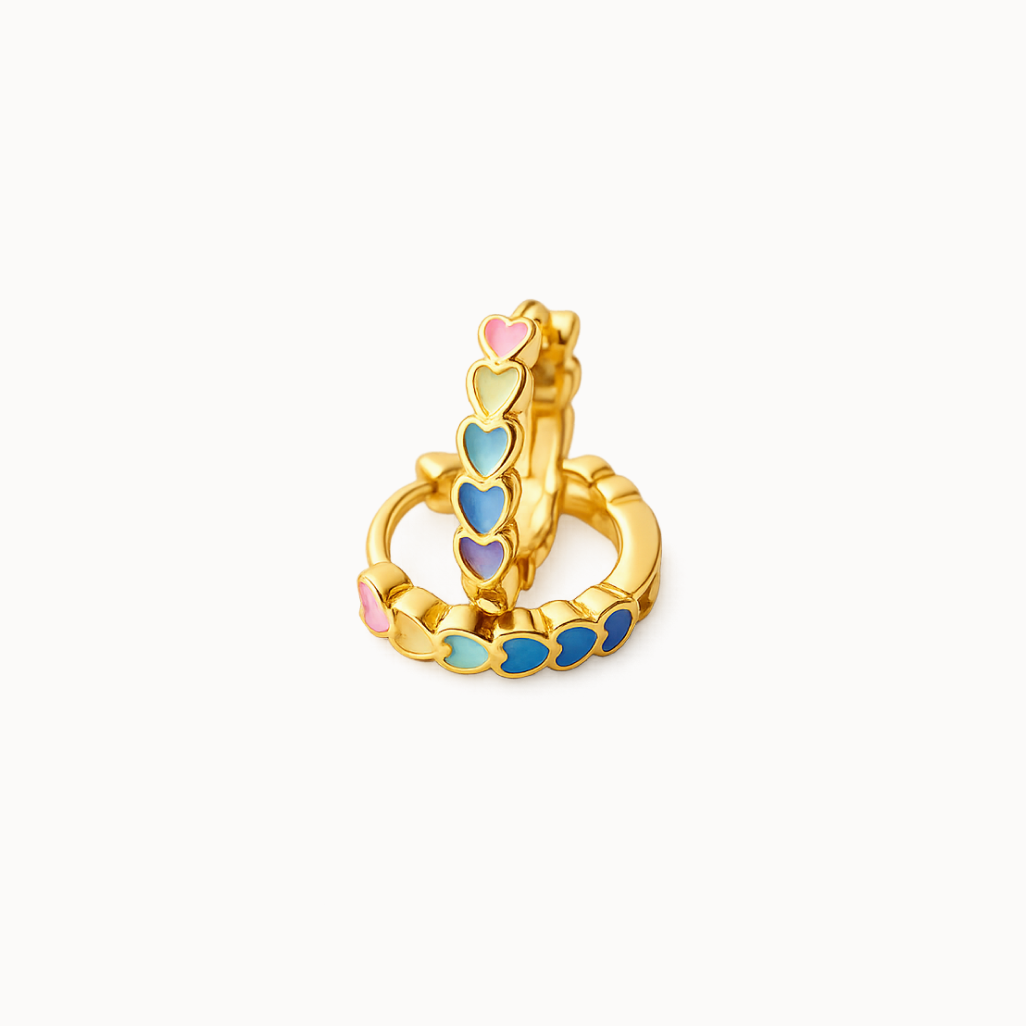 Gold earring huggies with colorful heart-shaped stones on a white background