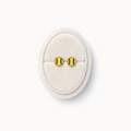 Pair of softball-themed earrings on a white cushion against a white background