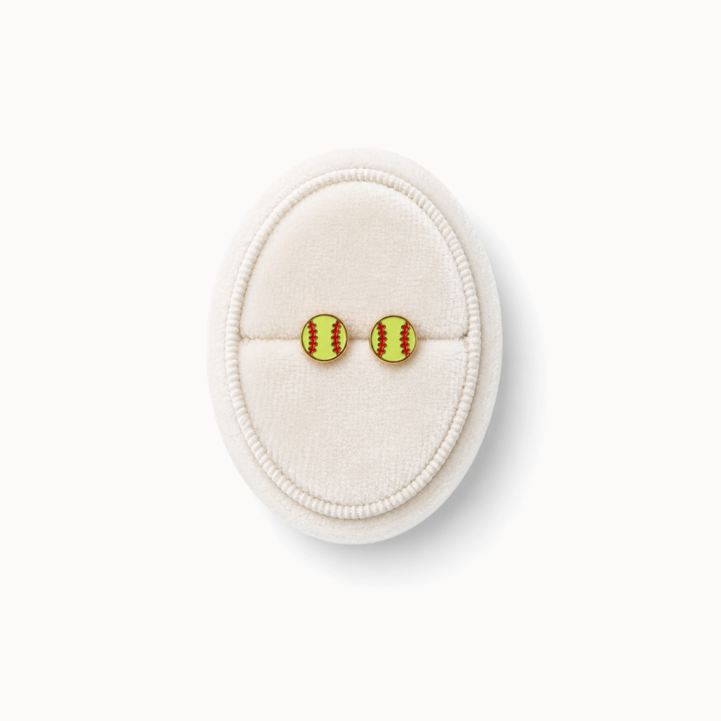 Pair of softball-themed earrings on a white cushion against a white background