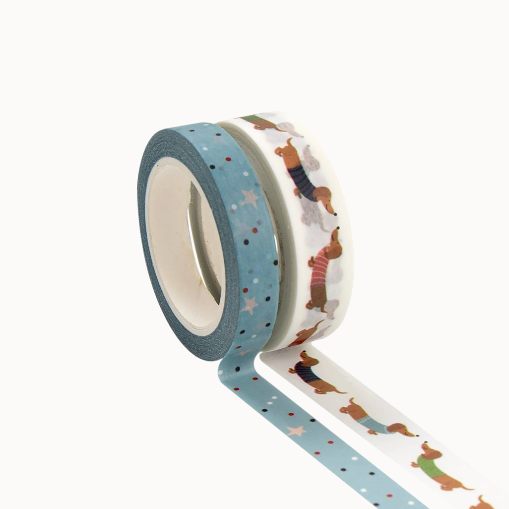 Two rolls of decorative tape with dog patterns on a white background