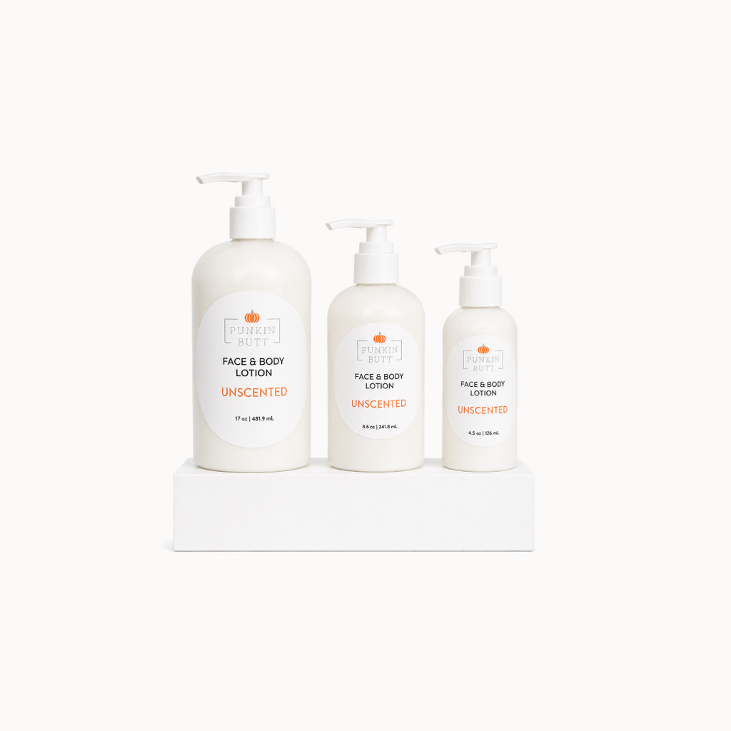 Three bottles of unscented face and body lotion on a white surface