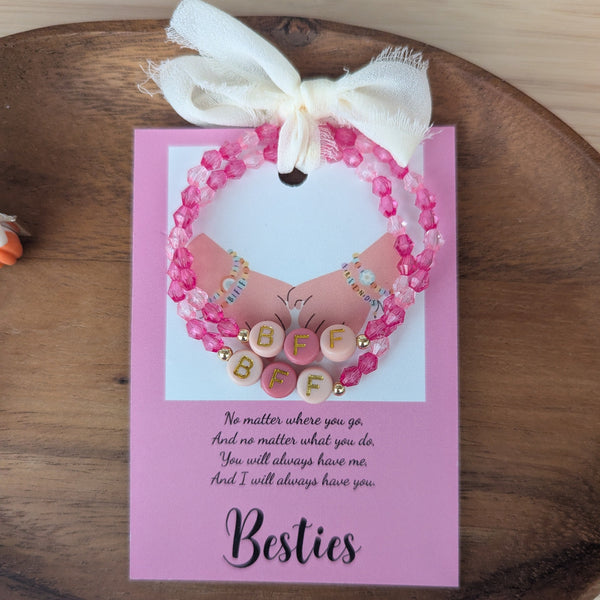 Pink card with decorative elements on a wooden surface