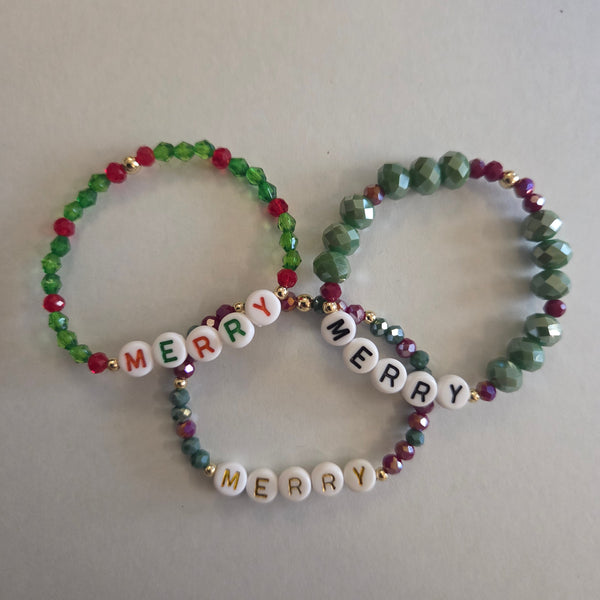Two beaded bracelets with 'Merry Christmas' text on a light gray background