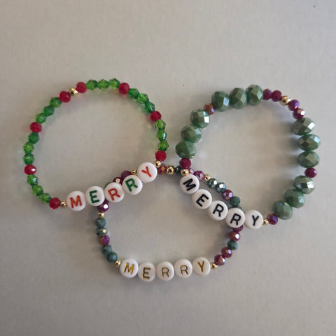 Two beaded bracelets with 'Merry Christmas' text on a light gray background
