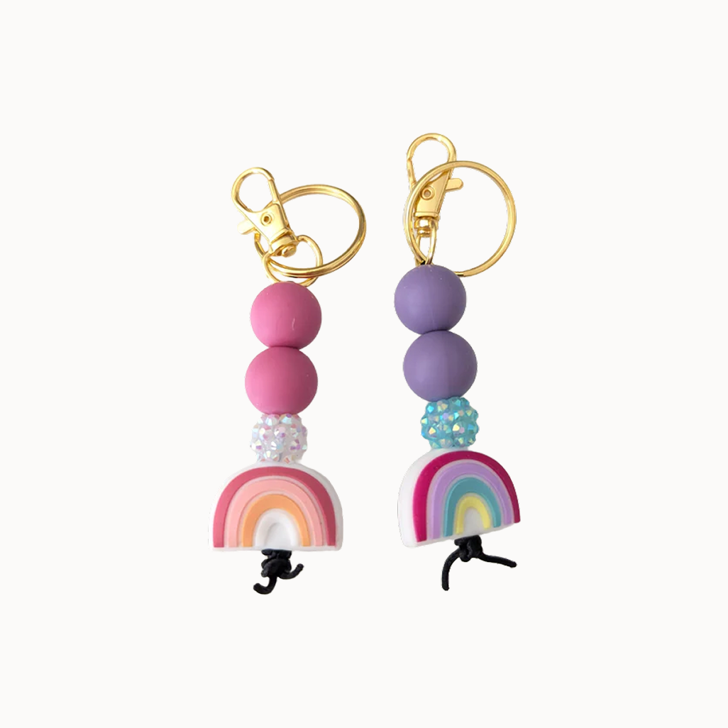 Two rainbow keychains, one pink and one purple