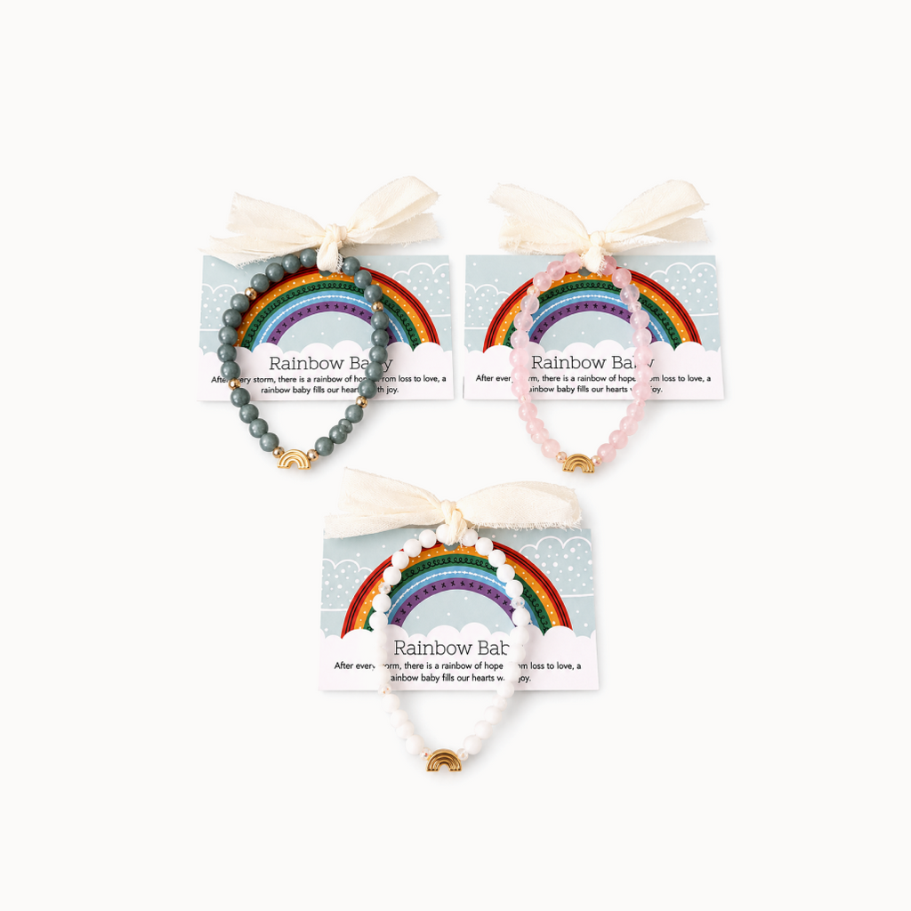 Rainbow baby bracelets in green, pink, and whie