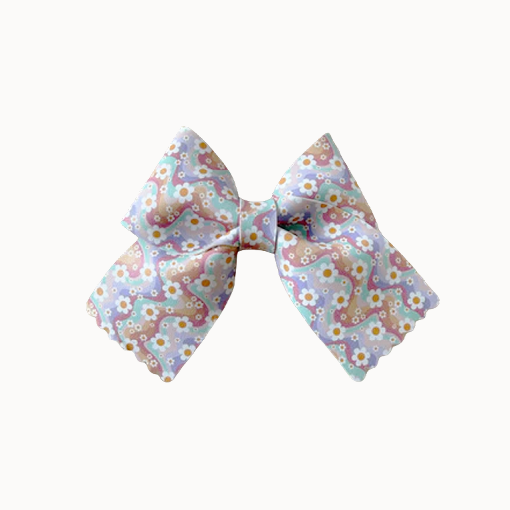 Classic hair bow with daisy and colorful waves print on a white background