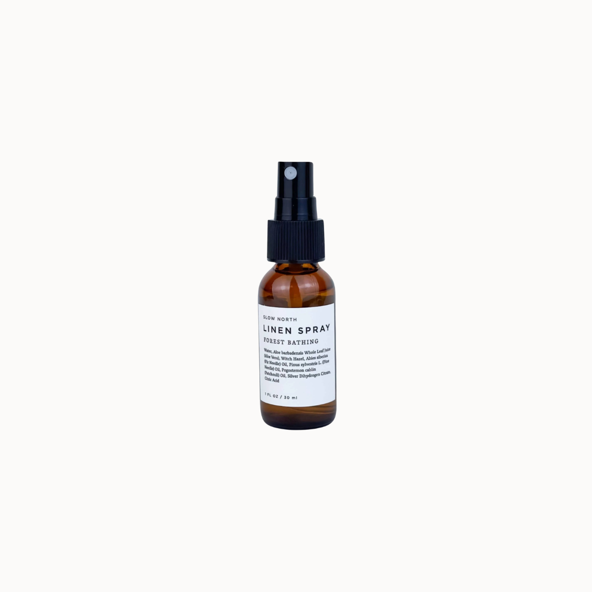 A small amber glass spray bottle with a black pump and a white label reading 'LINEN SPRAY' and 'FOREST BATHING', centered on a white background.