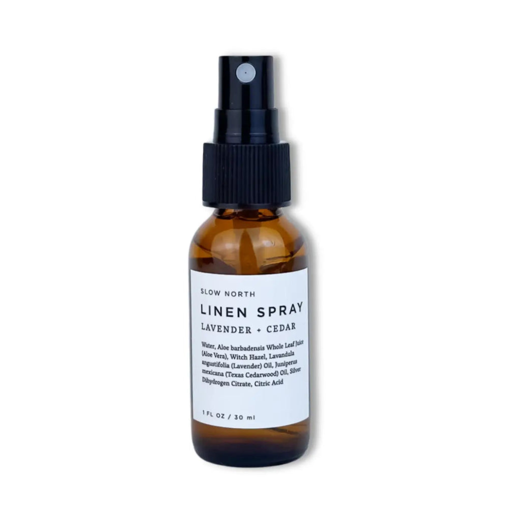 Linen spray bottle with lavender and cedar scent on a white background