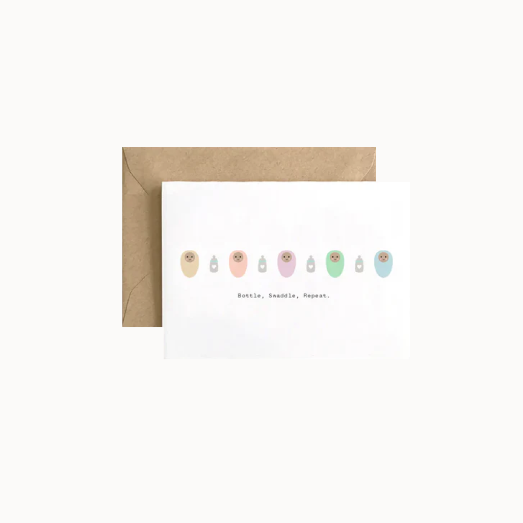 swaddled babies with bottles on white card on brown envelope