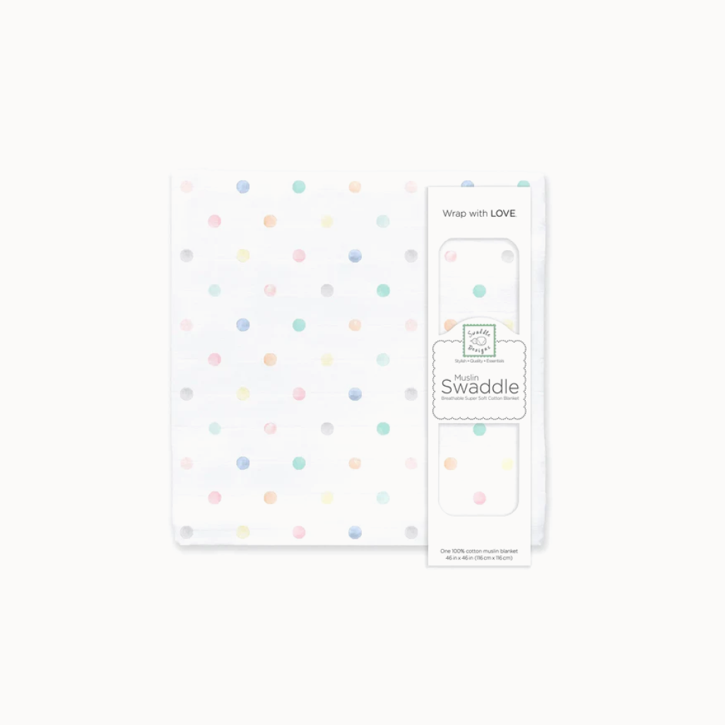 Cotton muslin swaddle blanket with colorful polka dots and packaging on a white background