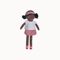 Doll with black hair buns, white shirt, and pink striped skirt