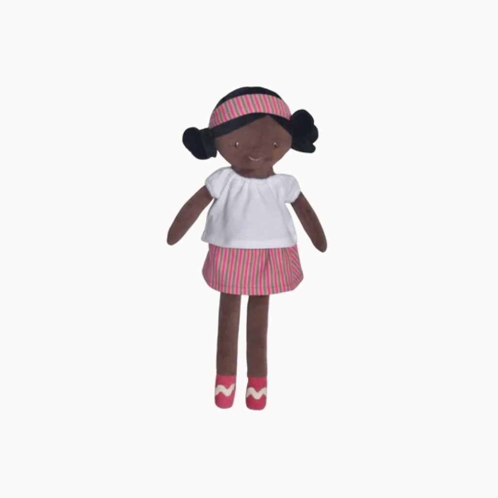 Doll with black hair buns, white shirt, and pink striped skirt
