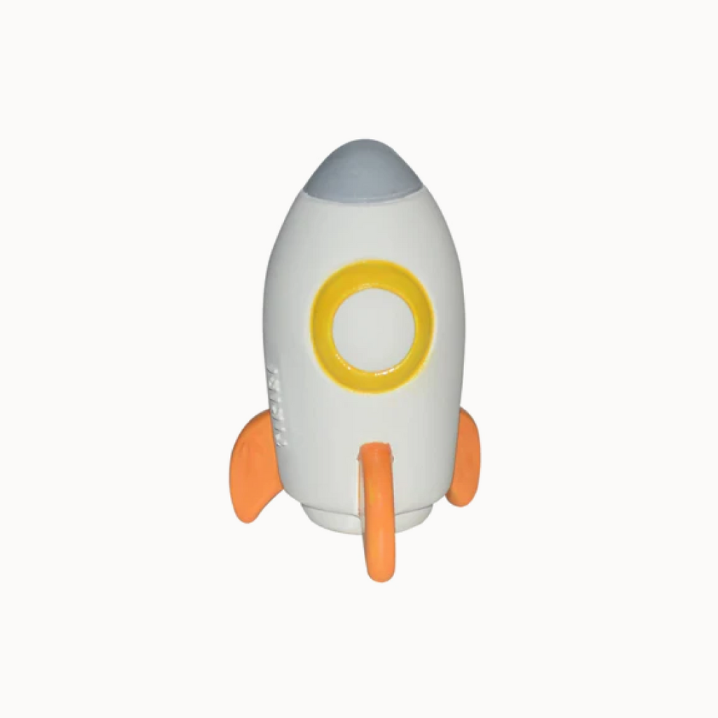 Toy rocket ship with a white body, gray top, yellow circle, and orange fins on a white background.