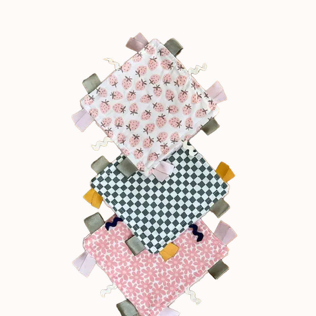 Three fabric tags with different patterns on a white background