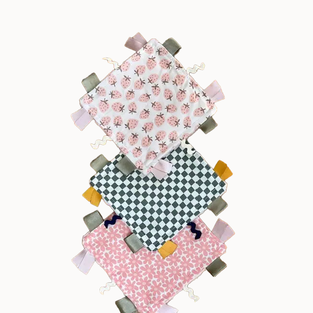 Three fabric tags with different patterns on a white background