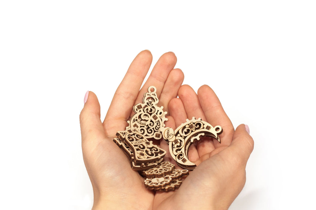 A person's hands holding wooden ornaments 