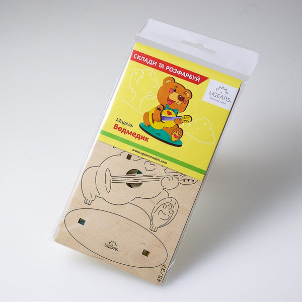 wooden toys in a package with a bear on it and UGEARS branding.