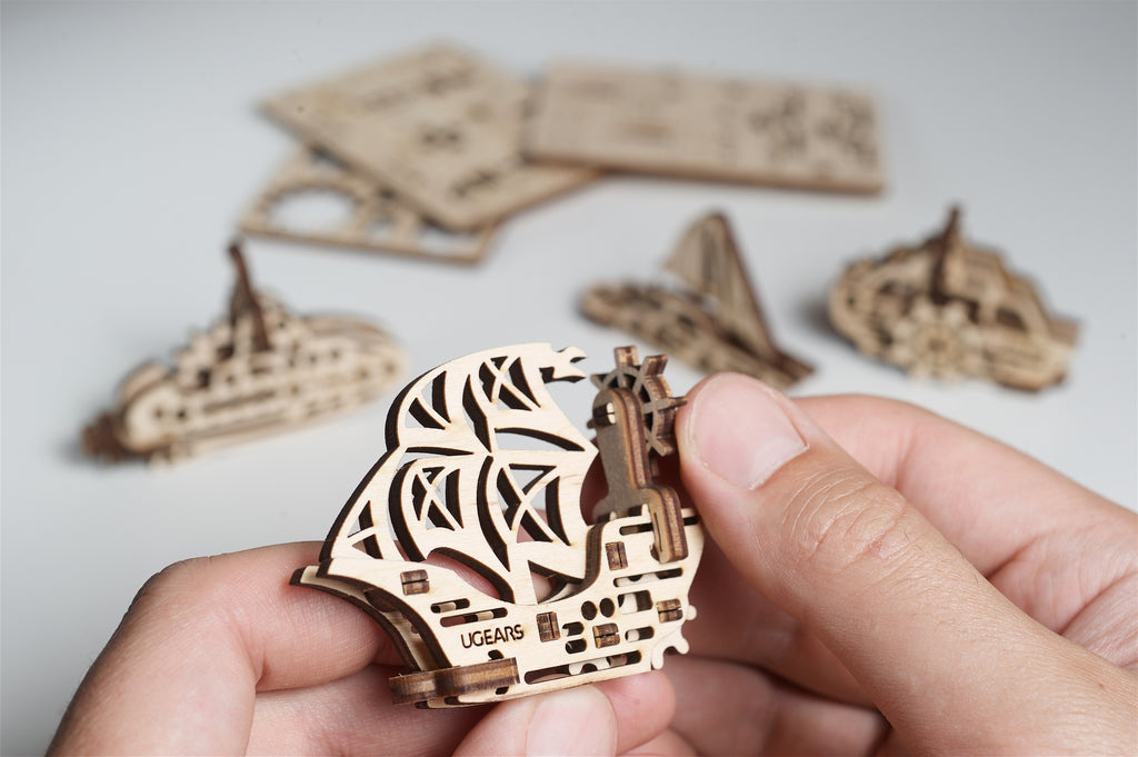 Hand holding wooden ship figure
