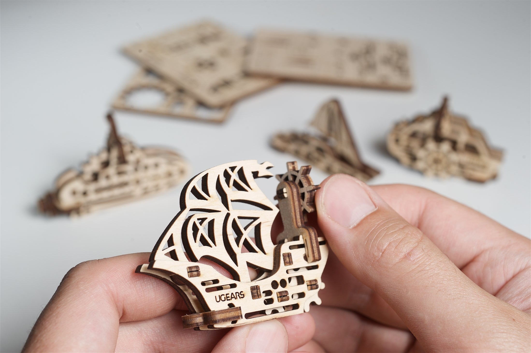 Hand holding wooden ship figure