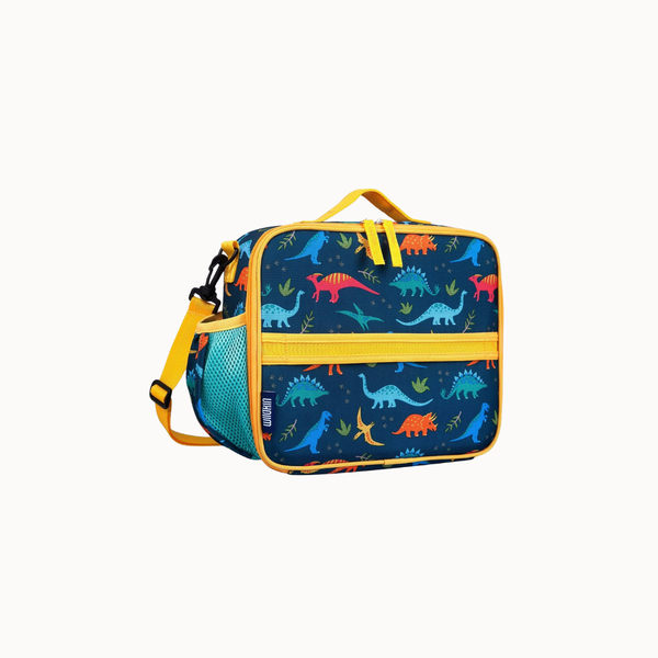 A square lunch bag with a dark blue background covered in a colorful dinosaur print, featuring bright yellow trim, a top handle, and a detachable shoulder strap.