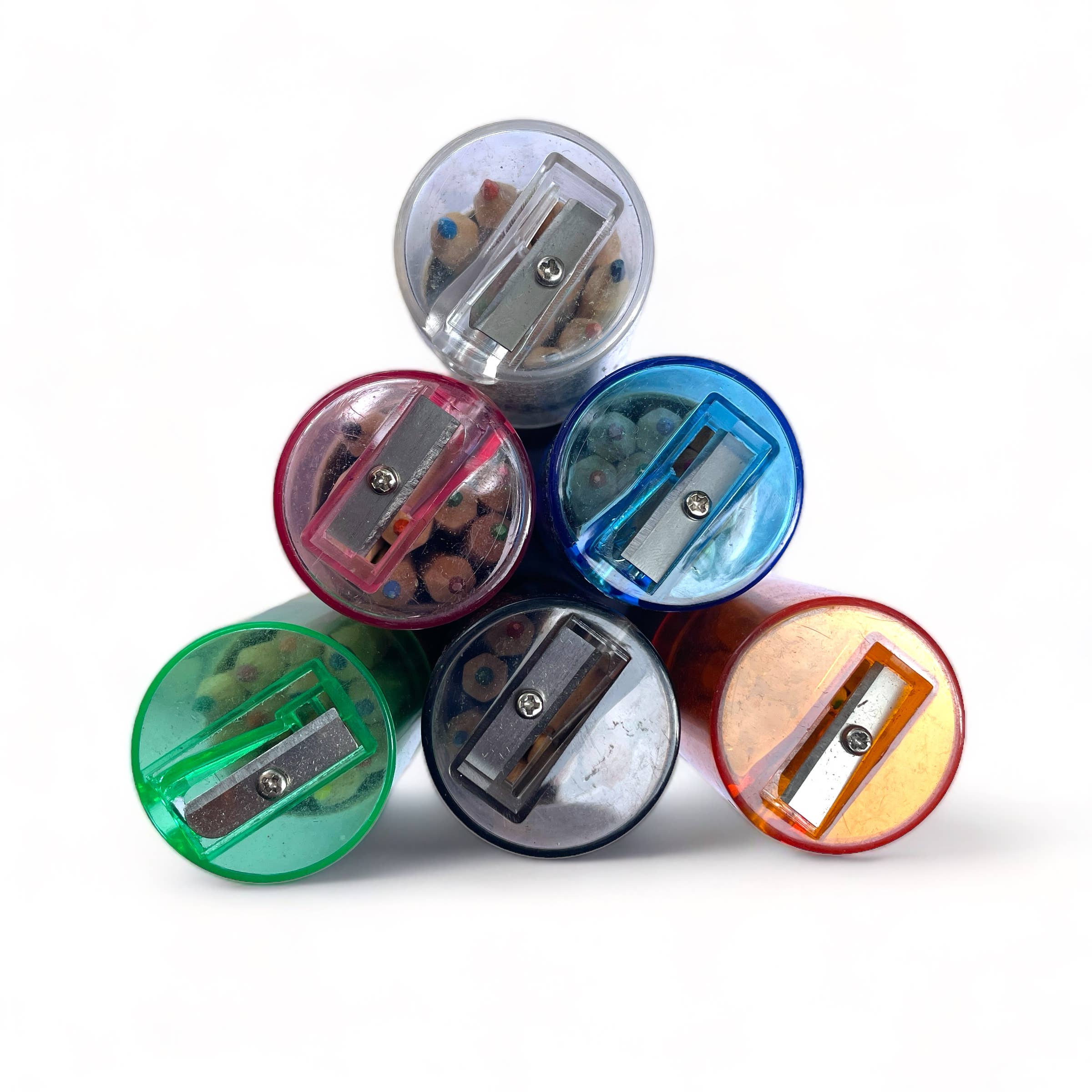 Colorful pencil sharpeners stacked on a white background