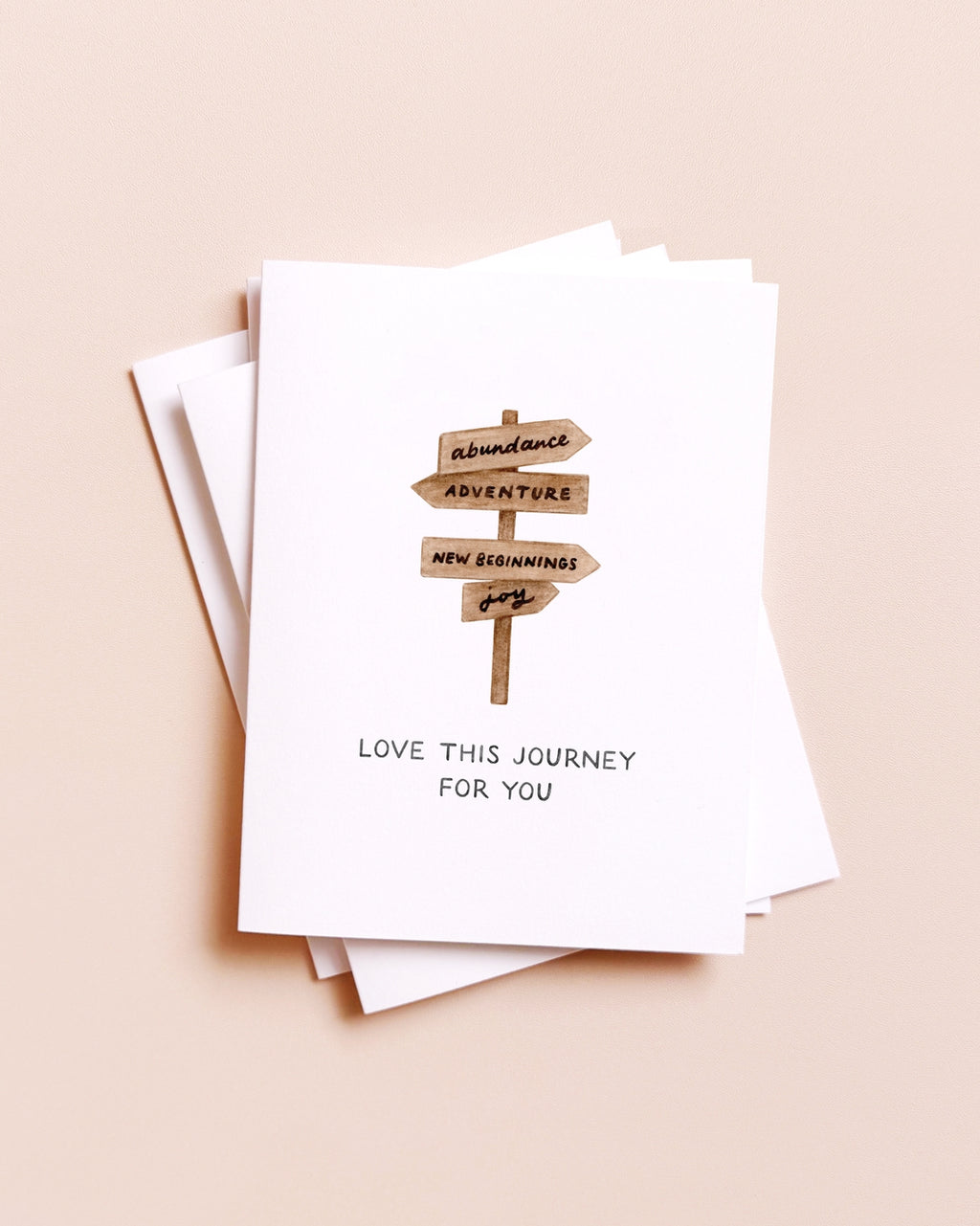 Stack of greeting cards with a blueberry illustration and text on a beige background
