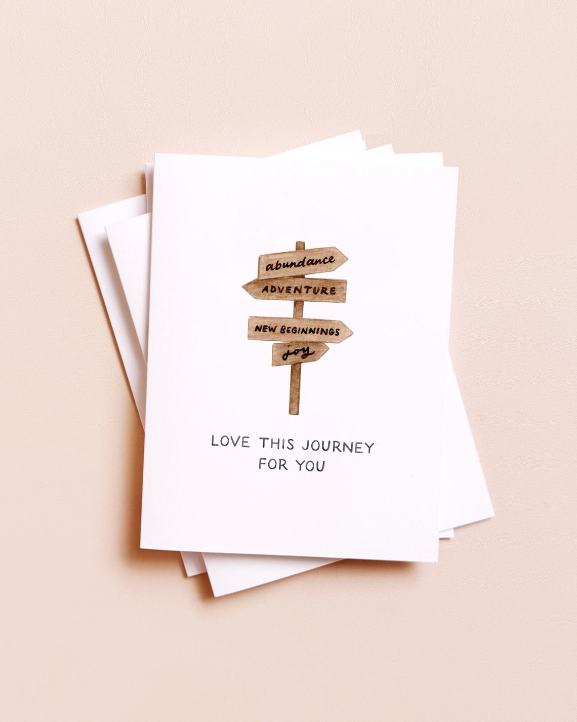 Stack of greeting cards with a blueberry illustration and text on a beige background