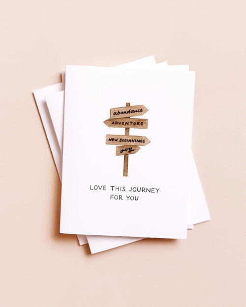 Stack of greeting cards with a blueberry illustration and text on a beige background