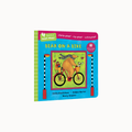 A children's board book titled 'Bear on a Bike' by Stella Blackstone and Henry Strater, featuring a colorful cover illustration of a bear riding a bicycle on a light gray background.