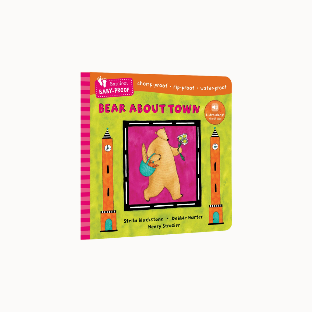 A children's board book titled 'Bear About Town' by Stella Blackstone and Dr. Brinkie Harter, featuring a colorful cover with a bear watering flowers between two towers, photographed on a light gray background.