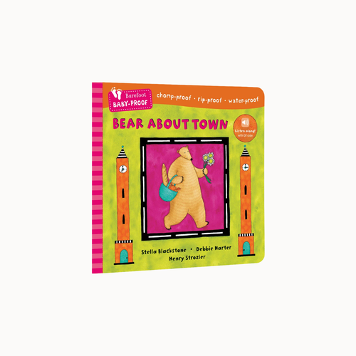 A children's board book titled 'Bear About Town' by Stella Blackstone and Dr. Brinkie Harter, featuring a colorful cover with a bear watering flowers between two towers, photographed on a light gray background.