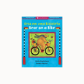 Children's book cover titled 'Urso em uma Bicicleta / Bear on a Bike' with a bright blue border and an illustration of a bear riding a bicycle, shown on a plain white background.